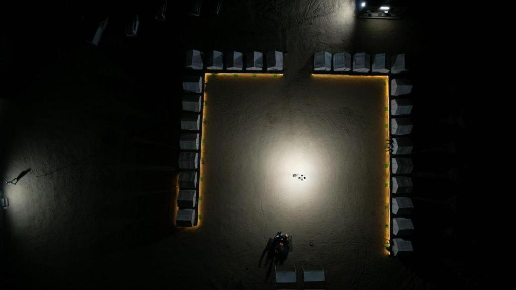 a person standing in a pool in the dark at Retreat Riyasat Desert Camp in Kūri