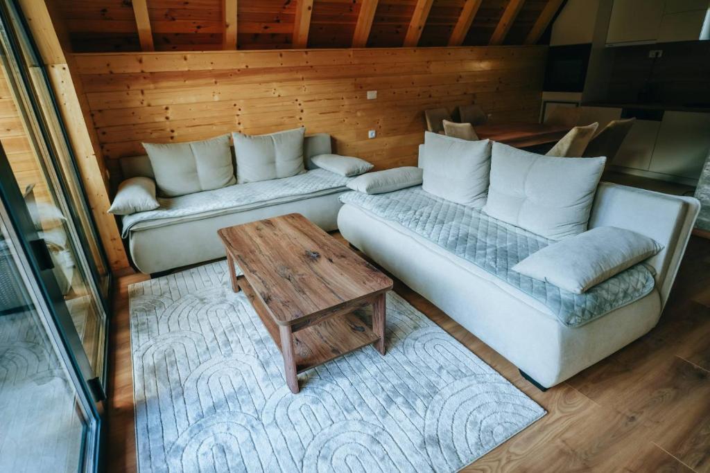a living room with a couch and a table at Ski Vista house in Žabljak