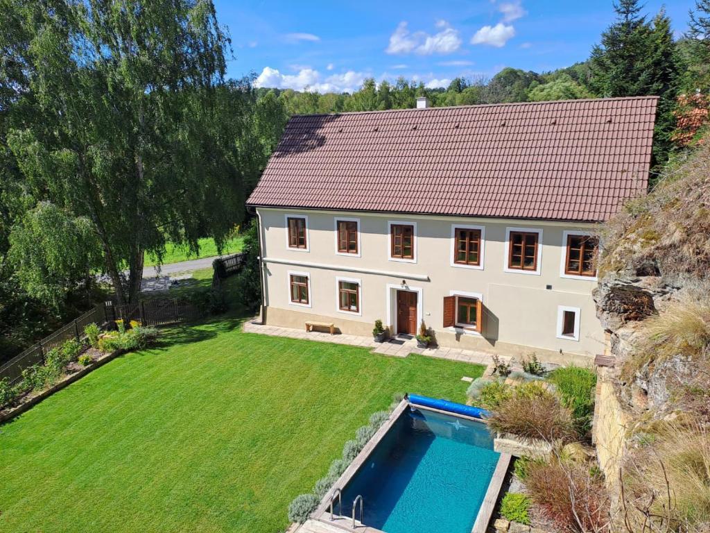 an aerial view of a house with a swimming pool at Chalupa Zátyní - celý objekt in Dubá