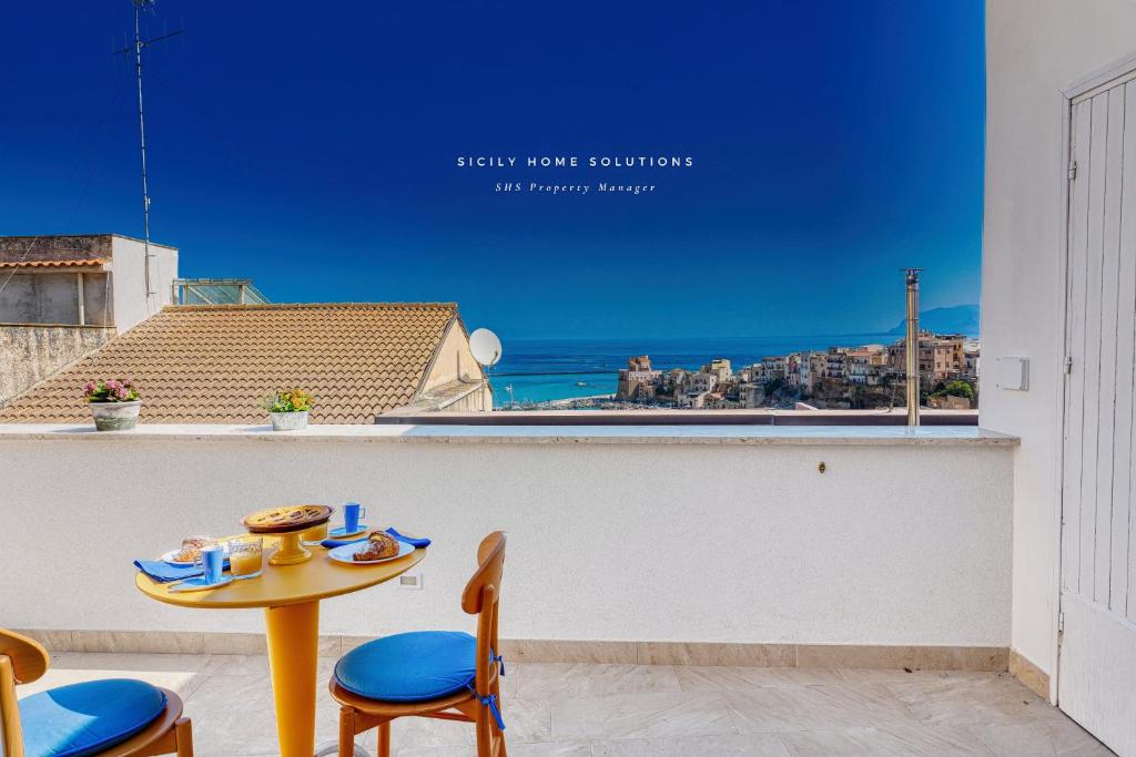 a table and chairs with a view of the ocean at Annina'S Home Panoramic sea view By Sicily Home Solutions in Castellammare del Golfo