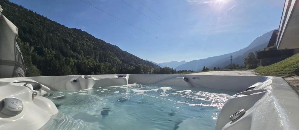 a hot tub with a view of a mountain at L'Aiguillon - Studio avec Jacuzzi pour 2 personnes et enfants proche stations - Idéal couple avec 1 enfant in Saint-Jean-de-Sixt
