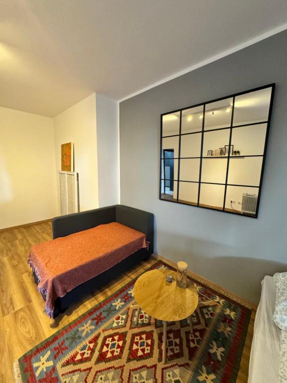 a bedroom with a bed and a table and a window at Duisburg Flats 24 in Duisburg