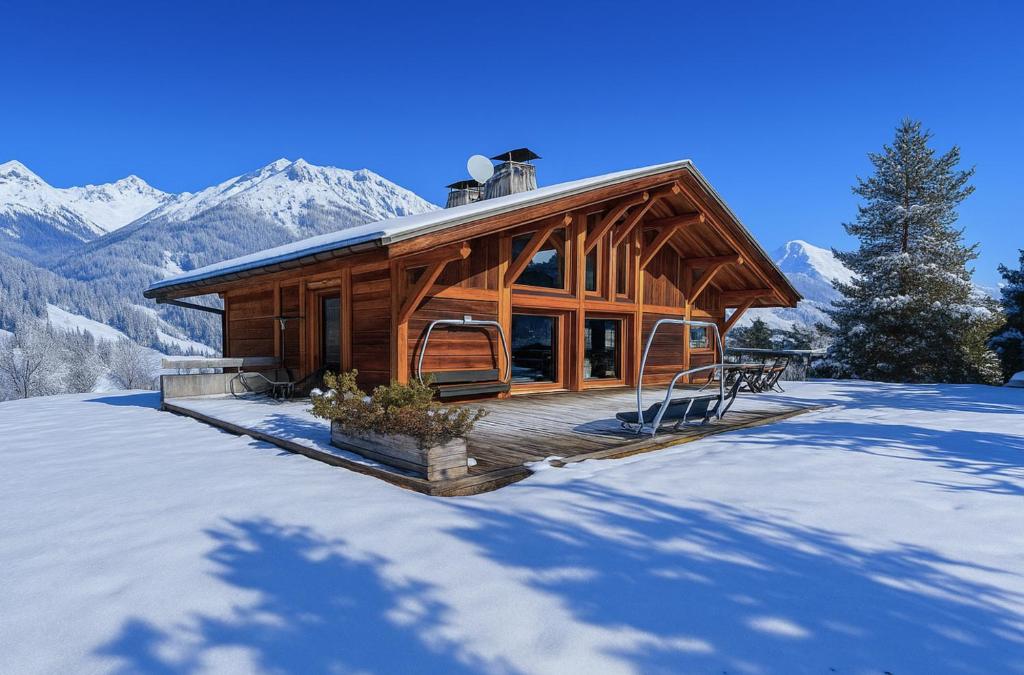 a log cabin in the snow with mountains at Large luxury chalet Megeve in Praz-sur-Arly
