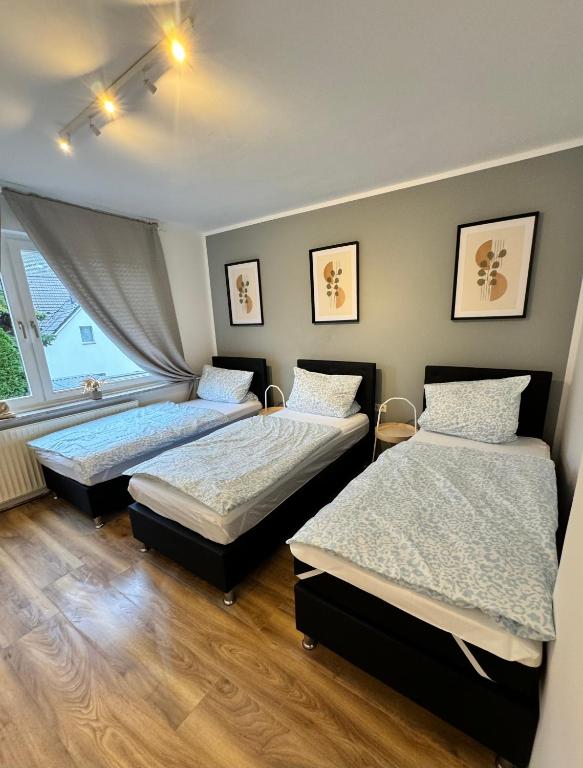 a bedroom with two beds and a window at Duisburg Flats 24 in Duisburg