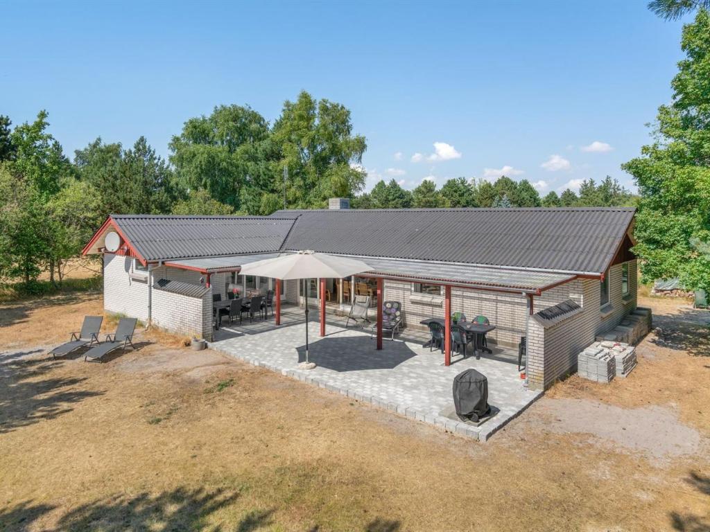 an overhead view of a shed with a table and umbrella at Holiday Home Sitta - 400m from the sea by Interhome in Rødby
