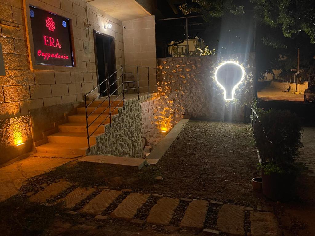 a light on the side of a building at night at Era Cappadocia in Uçhisar