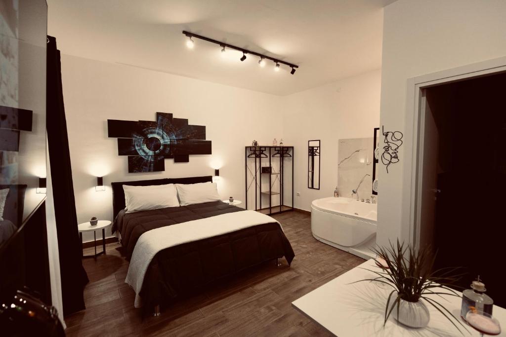 una camera da letto con un letto e una vasca da bagno di Elene Suites Boutique a Palermo