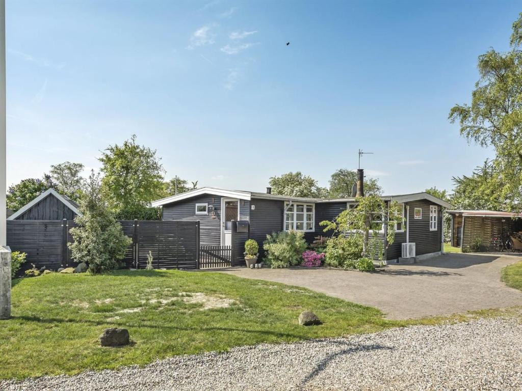 a house with a driveway in front of it at Holiday Home Tyyni - 75m from the sea by Interhome in Broager