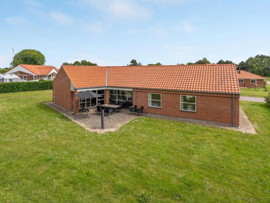 a small brick house with a large yard at Holiday Home Fengur - 330m from the sea by Interhome in Humble