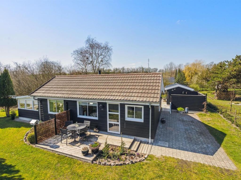 a tiny house with a patio and a backyard at Holiday Home Anisa - 400m from the sea by Interhome in Haderslev