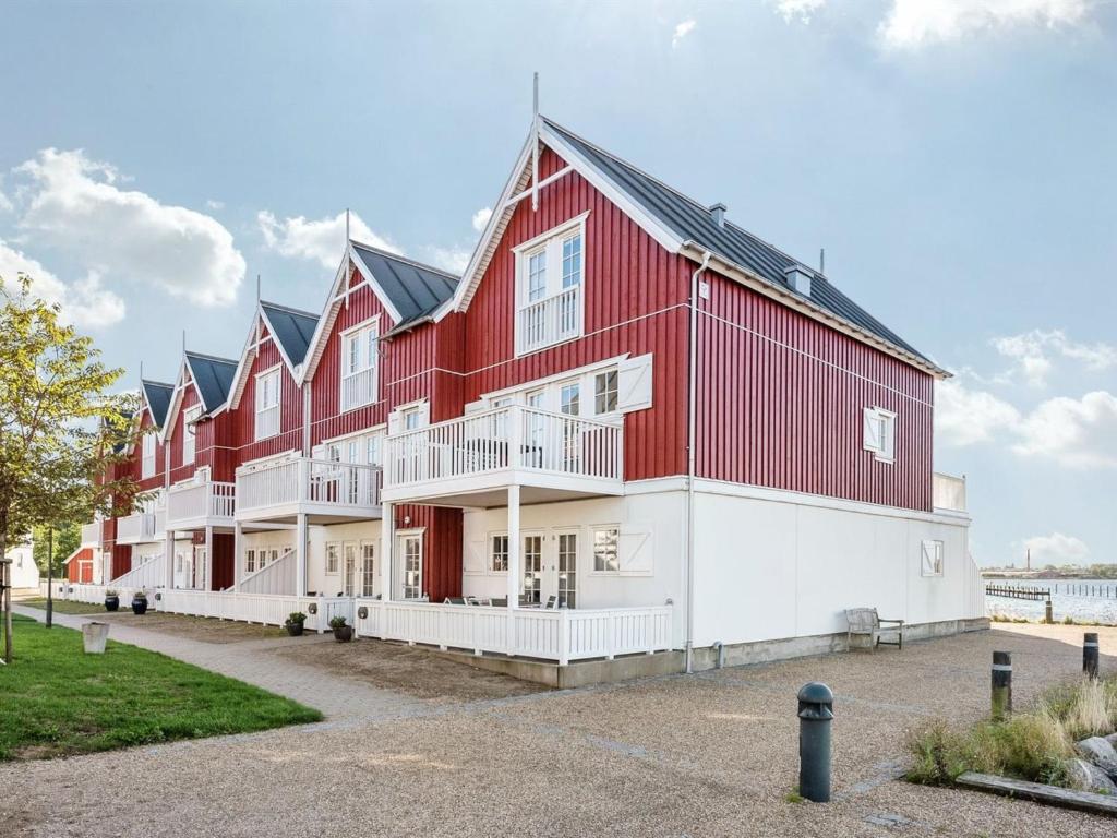 a large red and white building with a yard at Apartment Joar - 5m to the inlet by Interhome in Gråsten