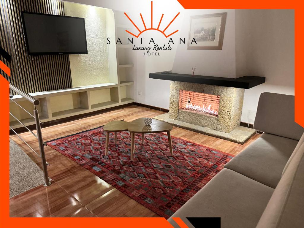 a living room with a fireplace and a tv at Hotel Santa Ana Luxury Rentals - 111 in Estación El Salto