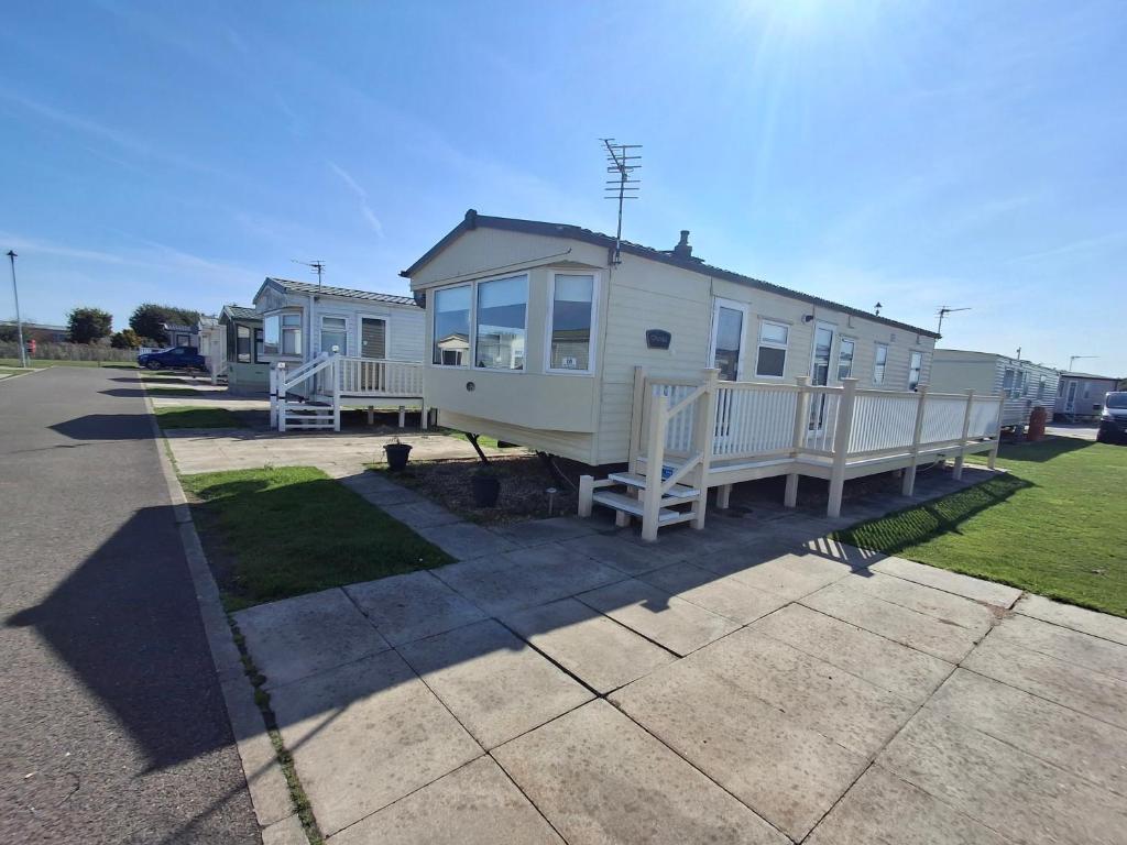 a mobile home on the side of a road at 3-Bed Caravan Sleeps 8 Pool & Beach in Chapel Saint Leonards