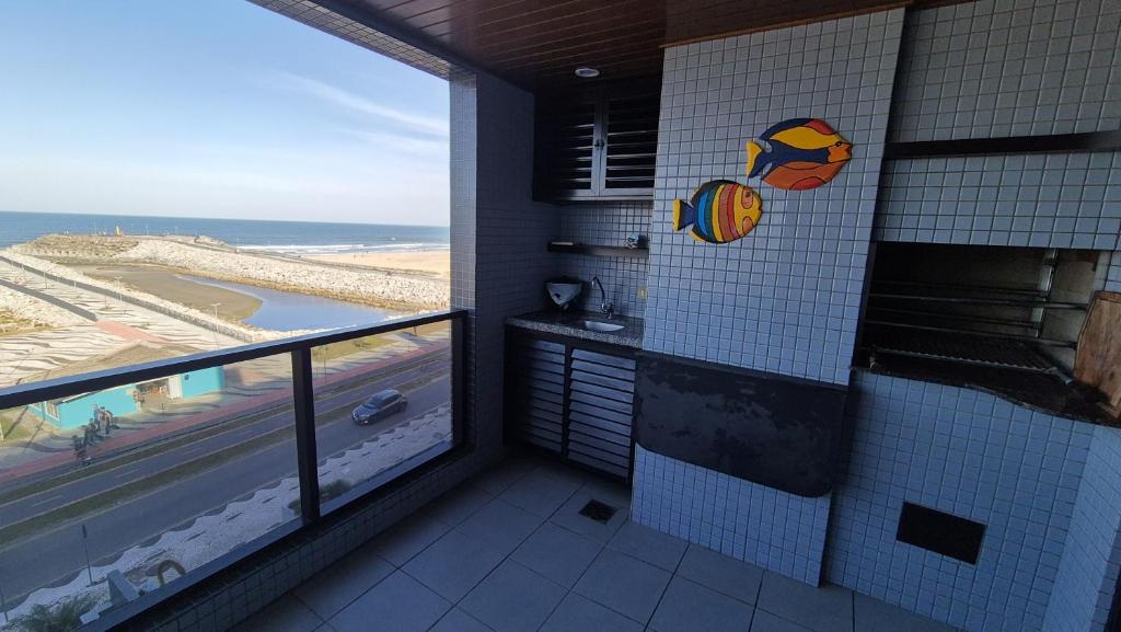 a bathroom with a shower with a view of the ocean at Ap Matinhos - Pé na areia e Vista para o Mar - Praia Brava - Caiobá in Matinhos