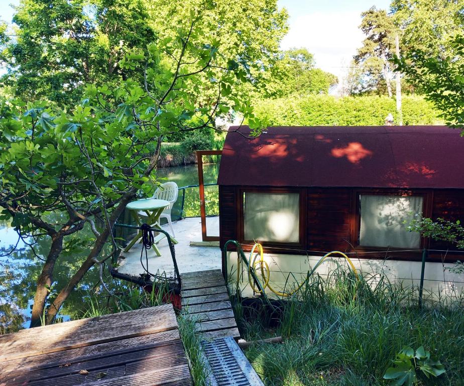 a red trailer with windows on a deck at Bateau sur le Canal du Midi in Ramonville-Saint-Agne