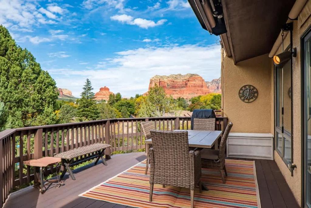 a balcony with a table and chairs with a view of the canyon at Spacious Sedona Splendor with Community Spa & Pool in Sedona