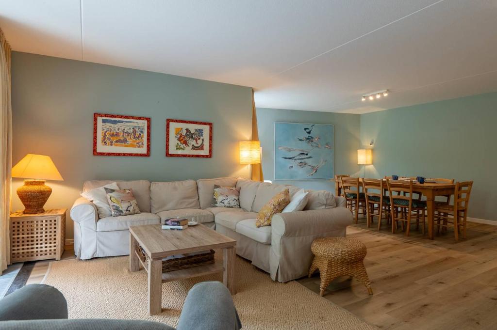 a living room with a couch and a table at Hello Zeeland - Appartement Park loverendale 25 in Domburg