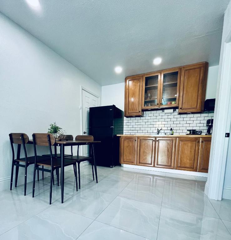 a kitchen with wooden cabinets and a table and chairs at Perfect go away in Fort Myers