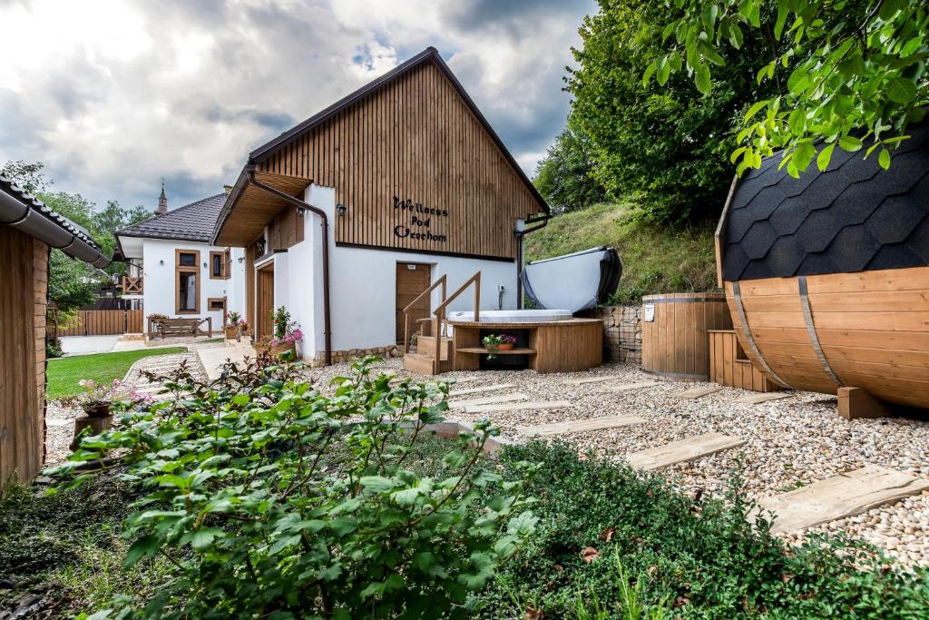 a garden with a house and a tub at Chata Vlčia Skala - wellness in Heľpa