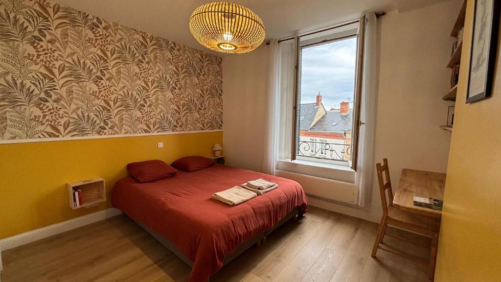 a bedroom with a red bed and a window at Hypercentral Champagne Nest in Épernay