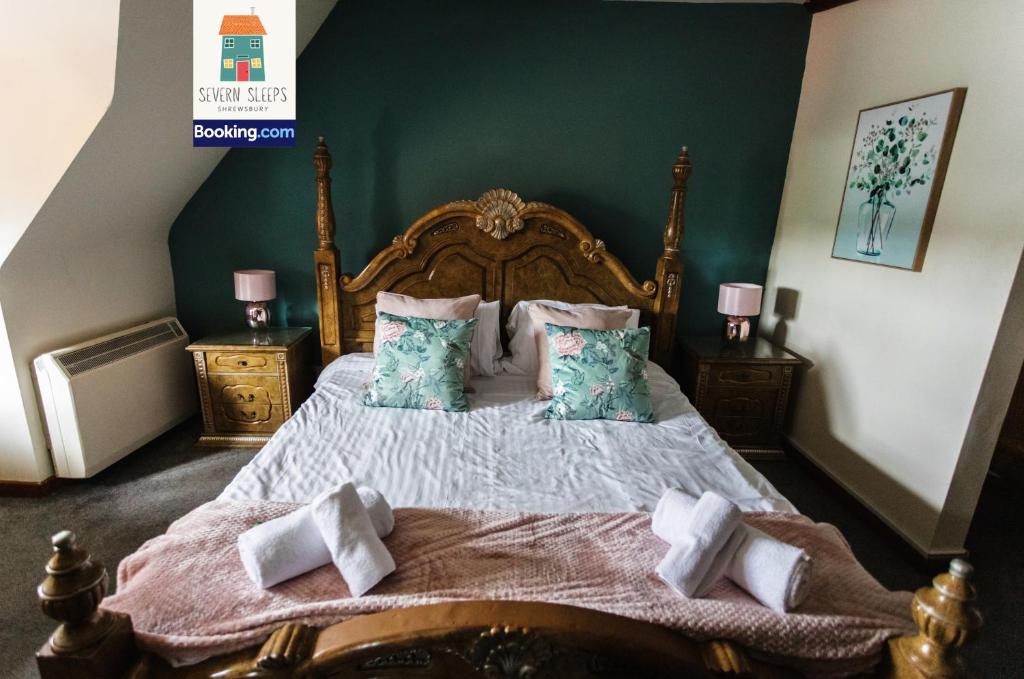 a bedroom with a large bed with green walls at Five Guest Rooms in Tudor House Frankwell Shrewsbury With Free WiFi in Shrewsbury