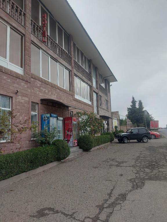 a car parked in front of a brick building at Kantegh Hotel in Ijevan
