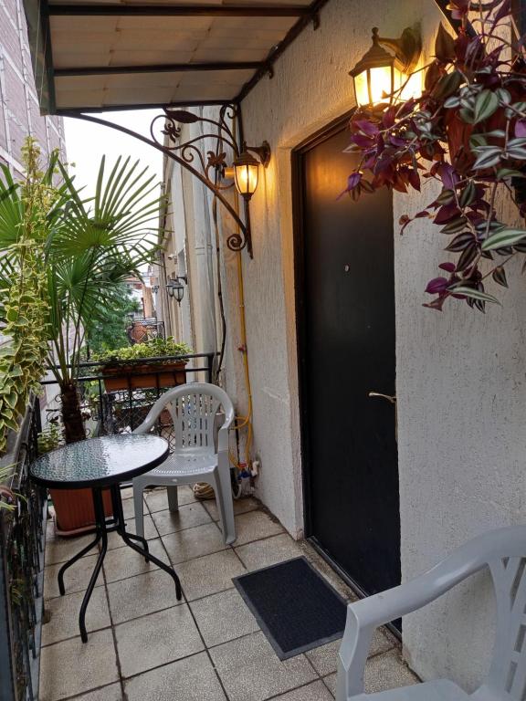 eine kleine Terrasse mit einem Tisch und Stühlen auf dem Balkon in der Unterkunft Old Tbilisi Narikala Apartment in Tbilisi City