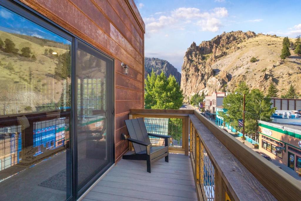 a balcony with a bench and a view of a mountain at OMI Combo in Creede, CO in Creede