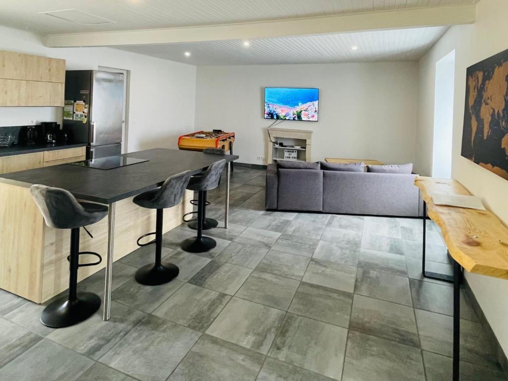 a kitchen and living room with a table and chairs at Maison proche de la Mer ! in Grues