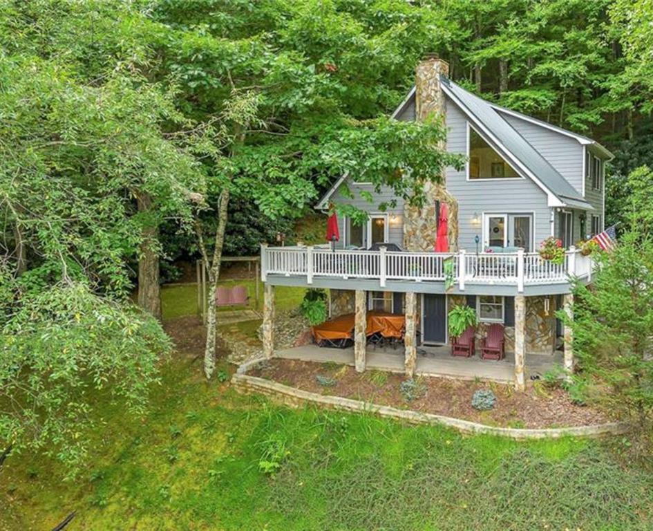 a white house with a porch and a deck at The 19Th Hole - New Rental 2025 in Beaver Creek