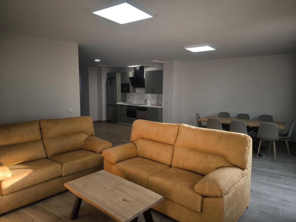a living room with two brown couches and a table at El Limonero de Alajar in Alájar