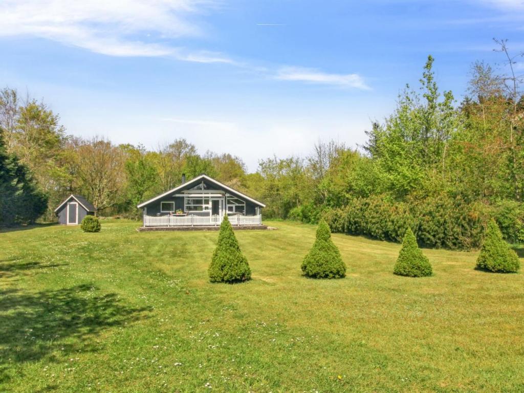 a house in a field with trees in the yard at Holiday Home Winter - 31km from the sea by Interhome in Toftlund