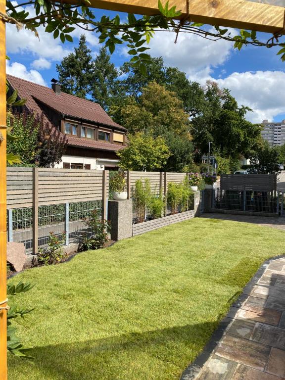 Modernes Ferienhaus mit Kochinsel, Garten, 2 Parkplätze inkl, 4-8 Pers في بوبلينغين: حديقة خلفية مع سور وعشب أخضر