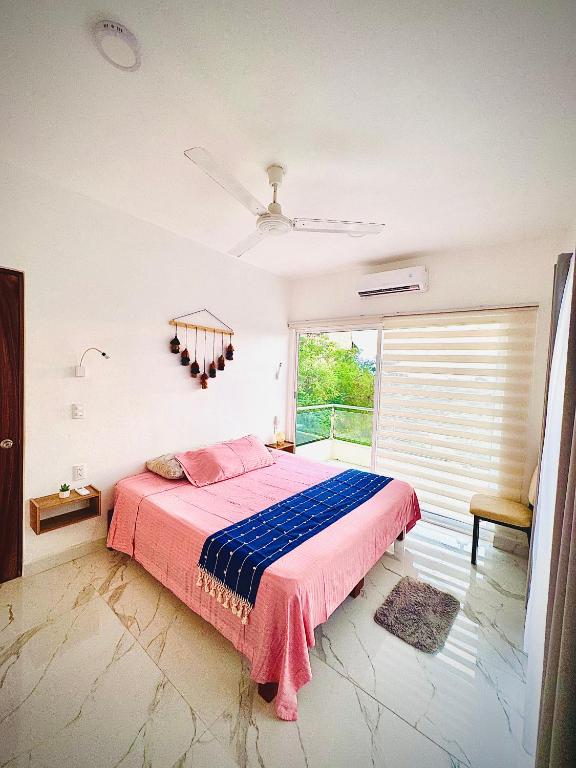 a bedroom with a bed and a window at Almare F4 in Puerto Escondido