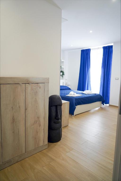 a bedroom with a bed and a chair in it at etna sea live catania center home in Catania