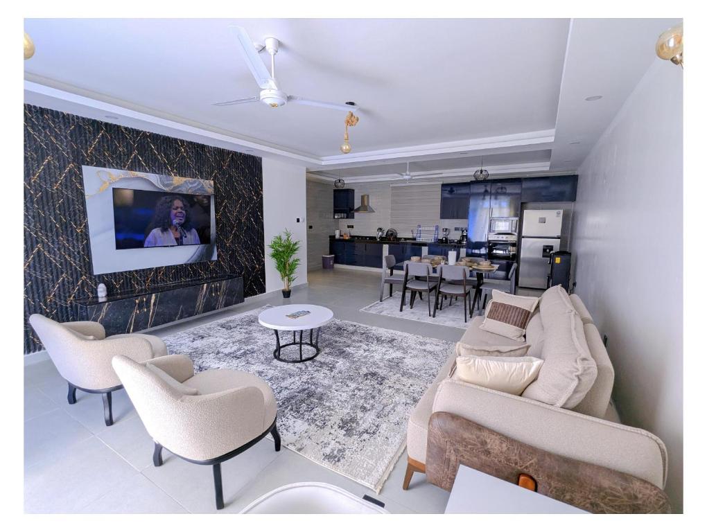 a living room with a couch and chairs and a table at Bahari elegance in Mombasa