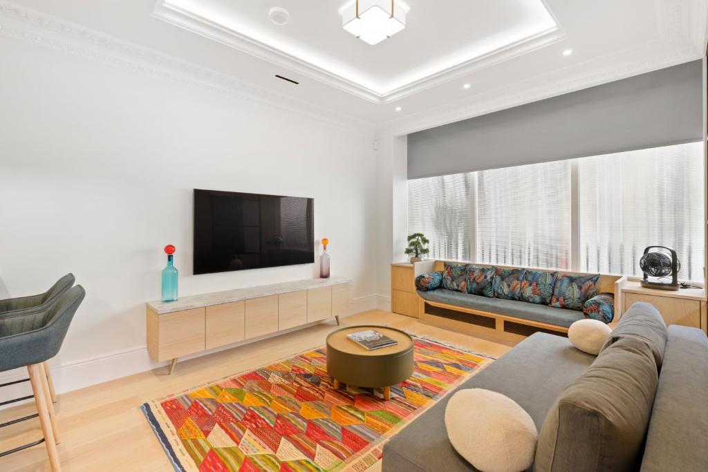 a living room with a couch and a flat screen tv at 1 Bed Flat in London in London