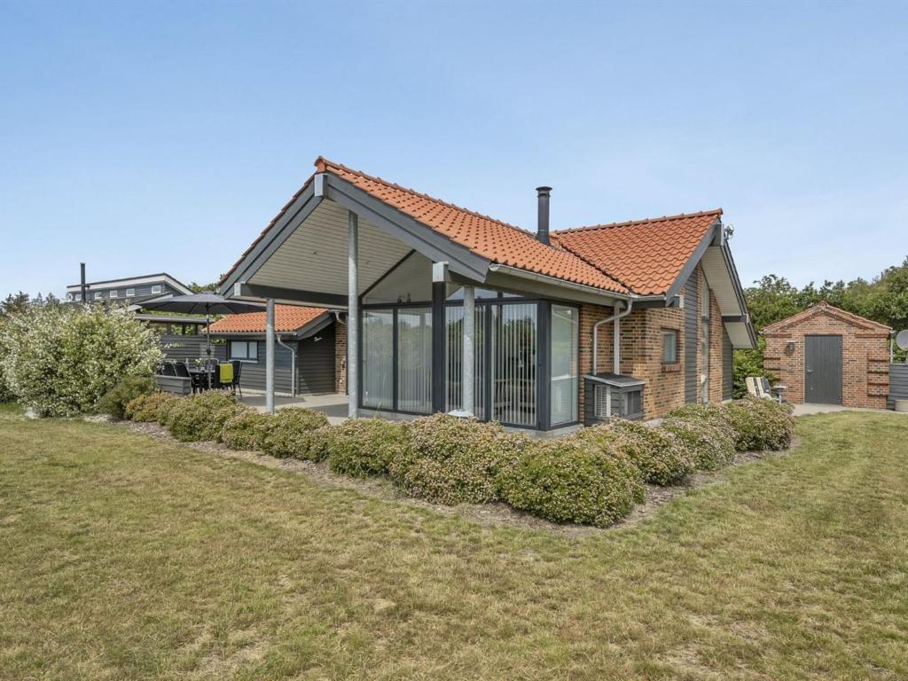 a house with a large yard in front of it at Holiday Home Donka - 300m to the fjord by Interhome in Skjern