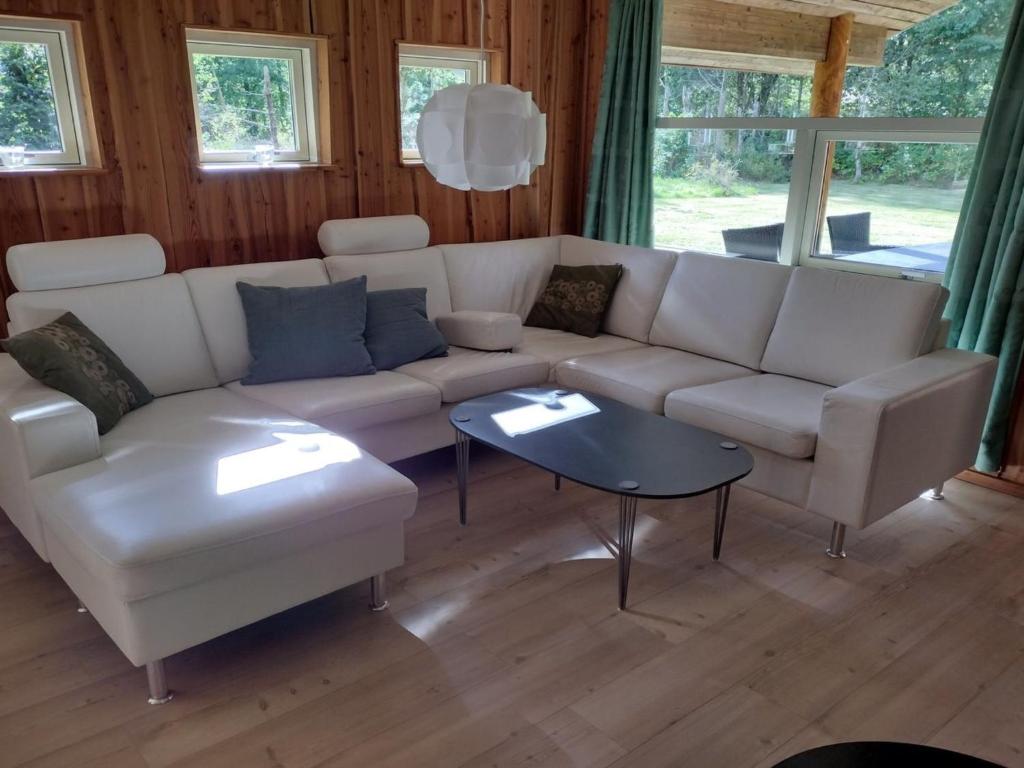 a living room with a white couch and a table at Holiday Home Tydulf - 34km from the sea by Interhome in Give