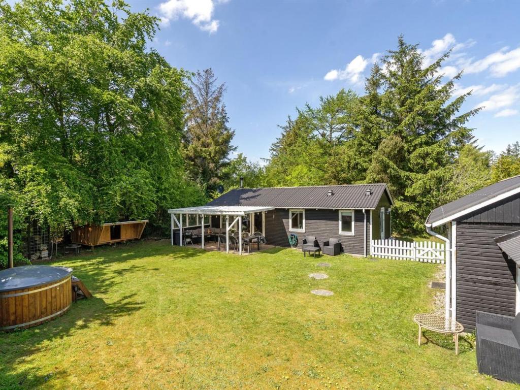 a yard with a house and a backyard with a gazebo at Holiday Home Ulrike - 600m to the fjord by Interhome in Ulfborg