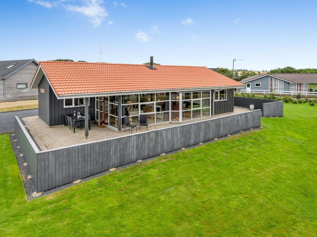 a house with a red roof in a yard at Holiday Home Malila - 400m to the fjord by Interhome in Vinderup