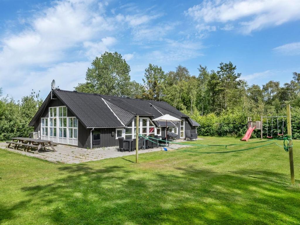 a house with a playground in the yard at Holiday Home Eisa - 300m to the fjord by Interhome in Øsløs