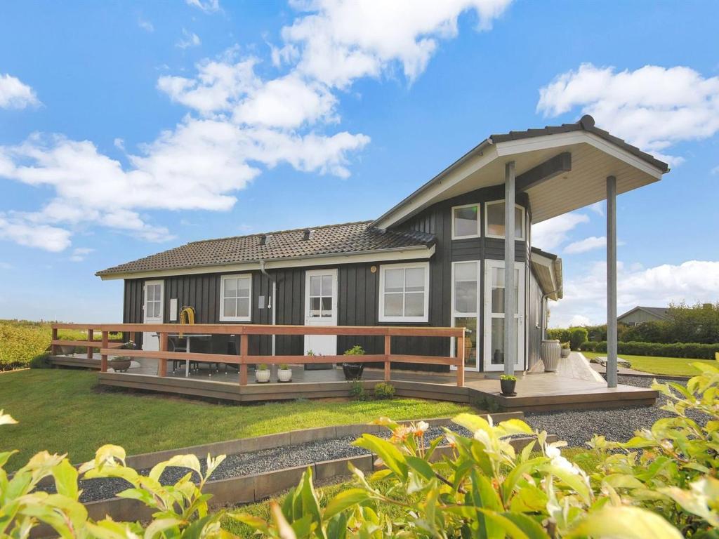 een groot huis met een groot terras in een tuin bij Holiday Home Eberta - 200m to the fjord by Interhome in Vinderup