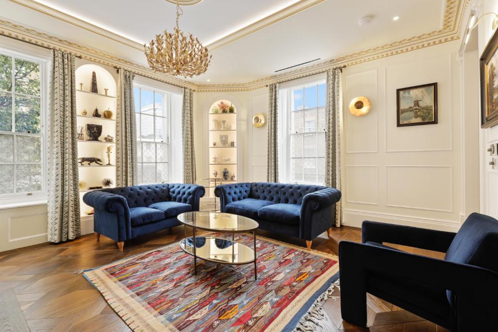 a living room with blue couches and a table at 3 Bedroom Flat in London in London
