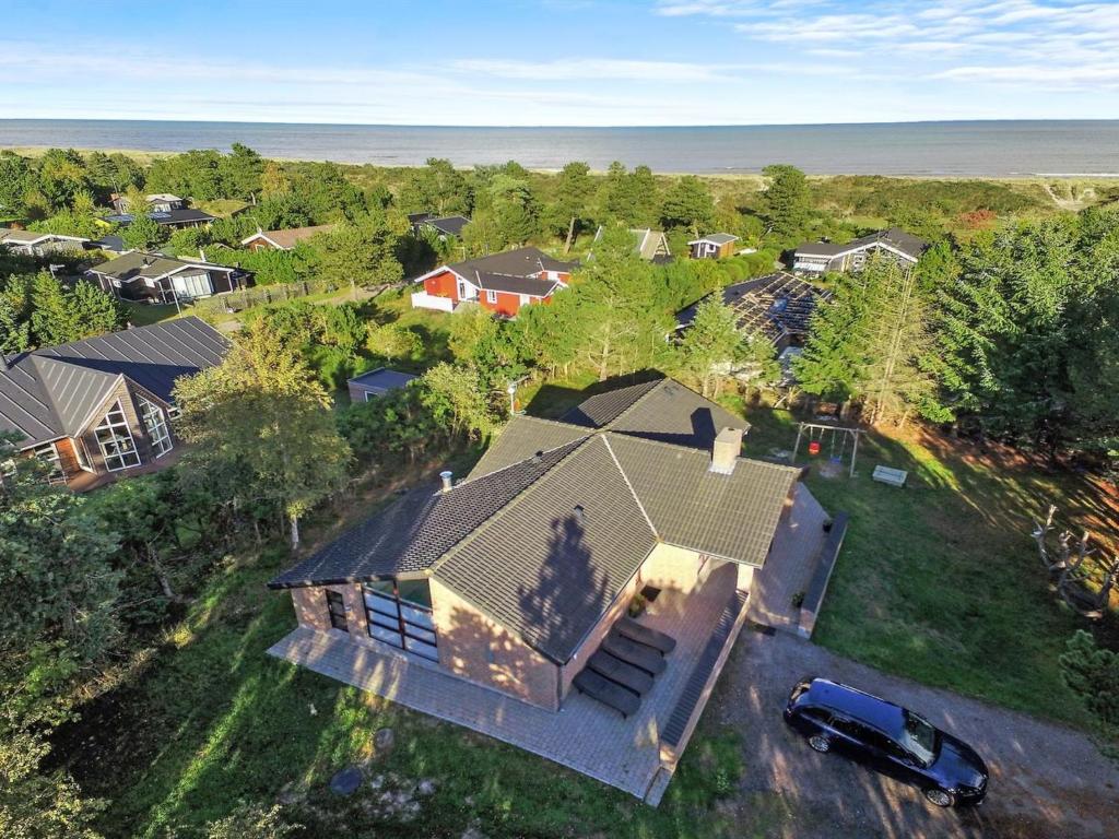 an overhead view of a house with a car in a yard at Holiday Home Ehlin - 150m from the sea by Interhome in Sæby