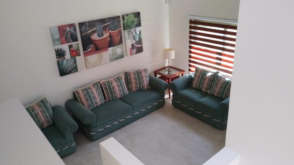 a living room with two couches and a table at BEAUTIFUL, gated and comfortable home in Santa Gertrudis
