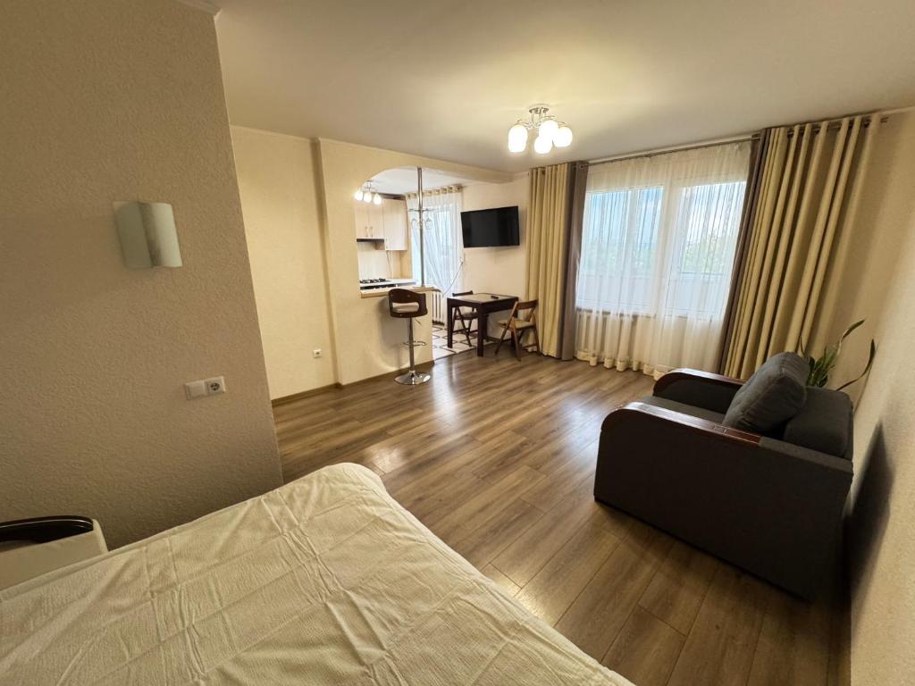 a living room with a couch and a table at квартира поруч з парком in Umanʼ
