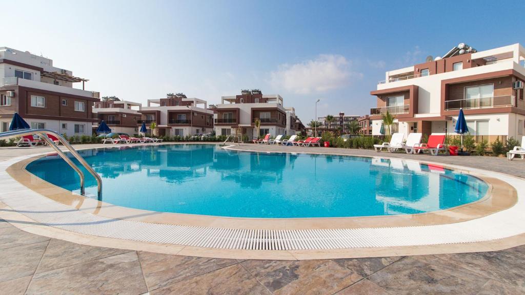 a large swimming pool in the middle of a building at Iskele Royal Sun Long Beach penthouse in Iskele