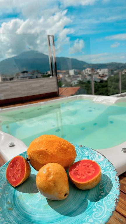 a plate of food on a table next to a pool at Penthouse with a privileged view in Governador Valadares