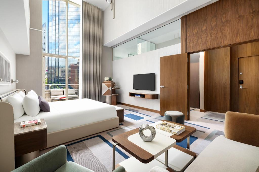 a bedroom with a bed and a living room at The Joule in Dallas